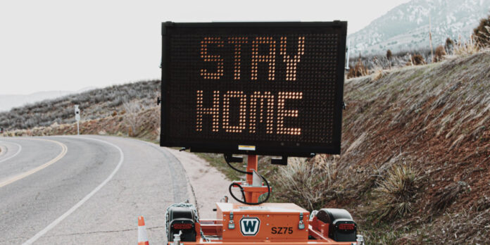 Road-side sign encouraging people to stay home during the coronavirus pandemic. Photo by LOGAN WEAVER on Unsplash.