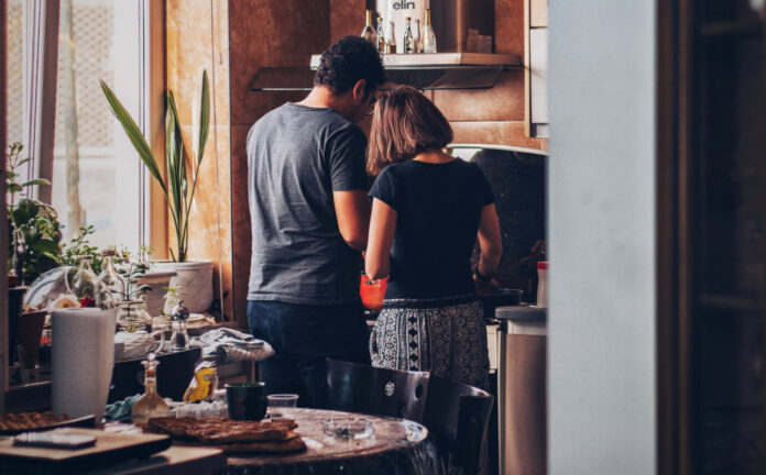 a couple cooking dinner