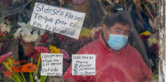 A florist in Brooklyn displays his wares. Photo by Julian Wan on Unsplash.