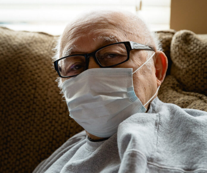 older man wearing mask, photo by Photo by Michael Williams II on Unsplash.