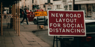Road sign on Social Distancing. Photo by Alex Motoc on Unsplash