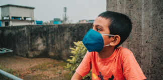 A young boy with a mask. Photo by Md. Shazzadul Alam on Unsplash