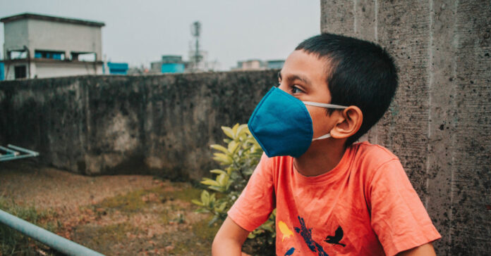 A young boy with a mask. Photo by Md. Shazzadul Alam on Unsplash