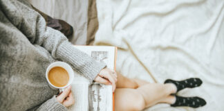Woman reading a book and enjoying a cup of coffee. Photo by Anthony Tran on Unsplash.