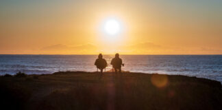 A couple watching the sunset. Photo by Anukrati Omar on Unsplash