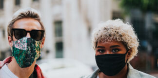 Two people in face masks. Photo by Nathan Dumlao on Unsplash