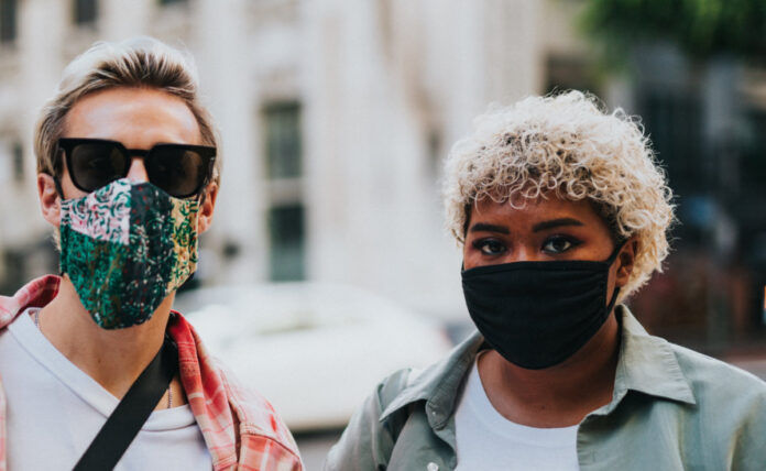 Two people in face masks. Photo by Nathan Dumlao on Unsplash