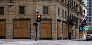 Boarded up storefront. Image by RJA1988 from Pixabay.