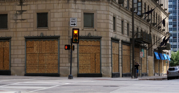 Boarded up storefront. Image by RJA1988 from Pixabay.