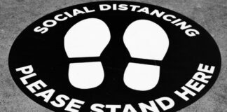 Social Distancing sticker telling people where to stand. Photo by Michael Marais on Unsplash