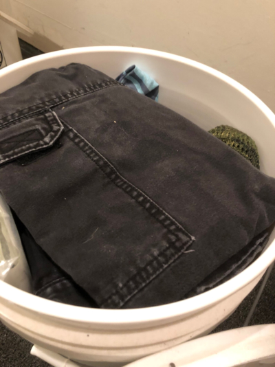 Folded pants in a bucket.