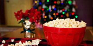 Popcorn in a bowl with a Christmas tree in the background. Photo by Jill Wellington from Pixabay.