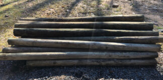 A pile of wooden fence posts.