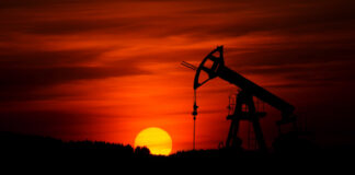 An oil pump at sunset. Photo by Zbynek Burival on Unsplash.