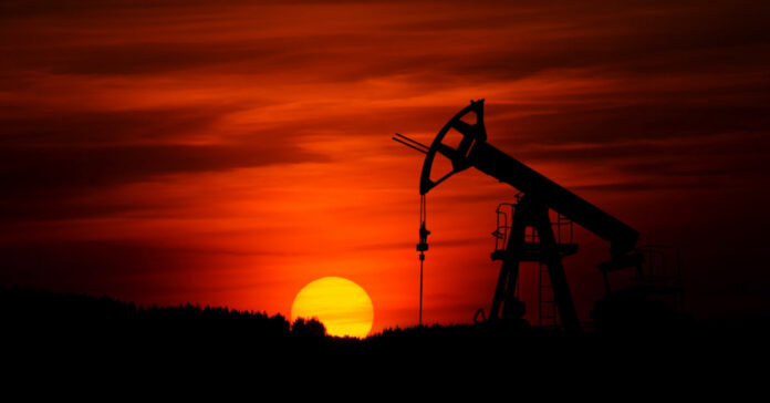 An oil pump at sunset. Photo by Zbynek Burival on Unsplash.