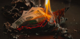 $100 bill burning