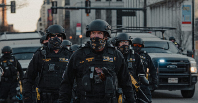police in combat gear representing force