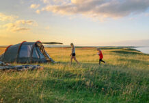 Prepper Recommendations for September 2026 A family camping in a tent. Photo by Mattias Helge on Unsplash.
