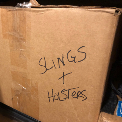 box of slings and holsters
