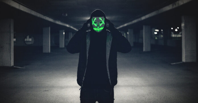 Man in a purge mask. Photo by Erik Mclean on Unsplash.