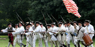 Line of revolutionary war soldiers with muskets