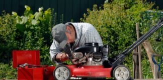 man repairing a lawnmower