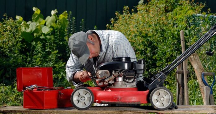 man repairing a lawnmower