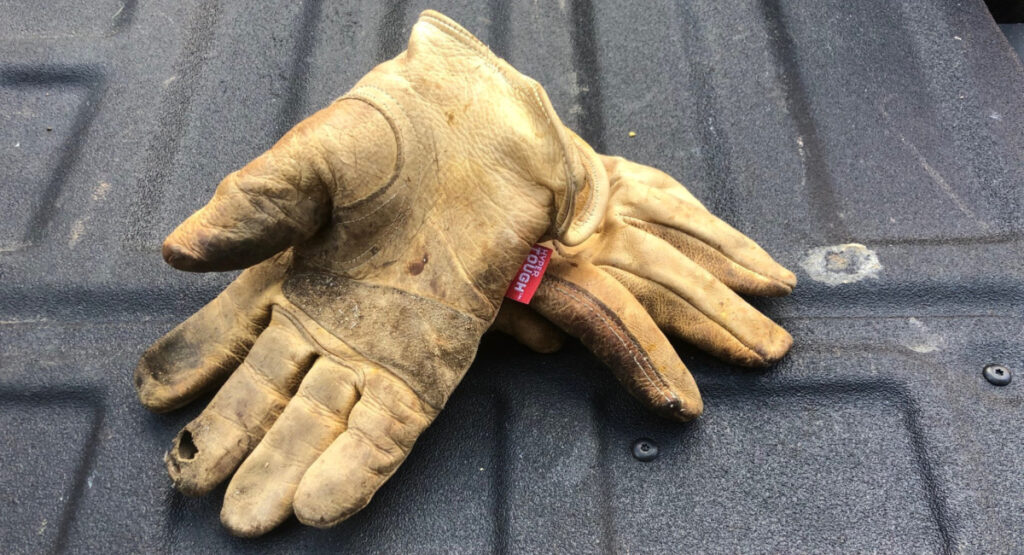 A well-used pair of leather work gloves