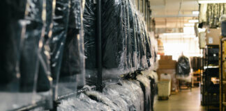 Clothes hanging at a dry cleaner.