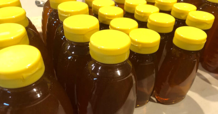 plastic bottle filled with amber honey