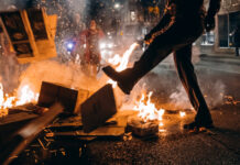 A protester starts a fire