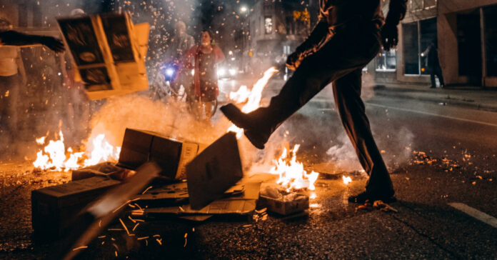 A protester starts a fire