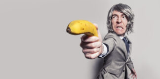 Man using a banana as a gun