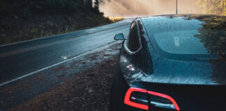 A Tesla on the side of a mountain road.