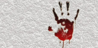 Bloody hand print on a white wall