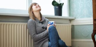 Woman sitting in front of a radiator