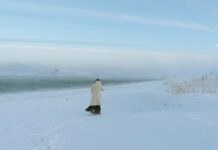Woman walks across a snowy field