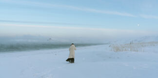 Woman walks across a snowy field