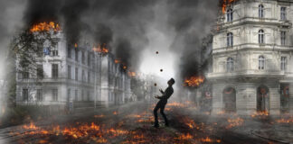 A man juggles while all about him a city burns.