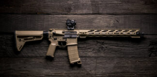 A Coyote Tan AR with a red dot optic.