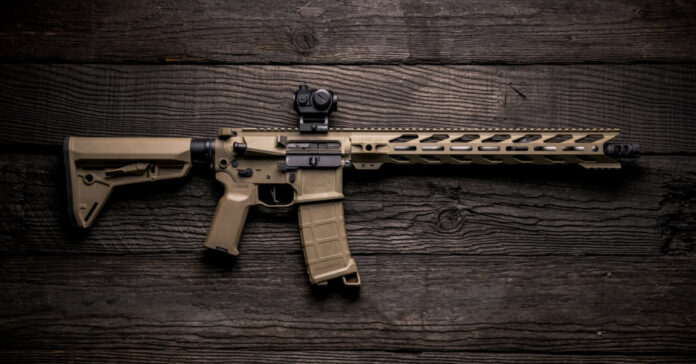 A Coyote Tan AR with a red dot optic.
