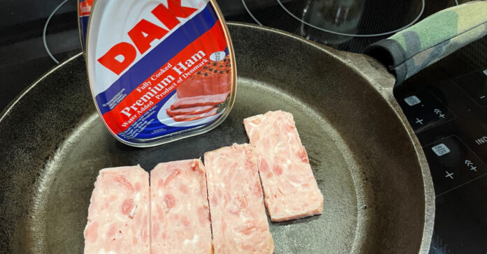Slices of canned ham in the frying pan.