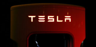 An illuminated Tesla logo