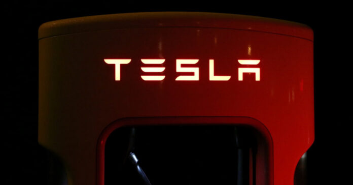 An illuminated Tesla logo