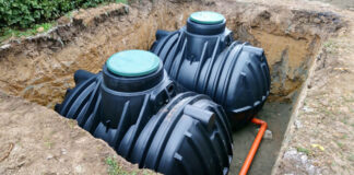 An example of septic tanks installed and waiting to be buried. The green lids should be at or near grade level to facilitate inspection, pumping and maintenance.
