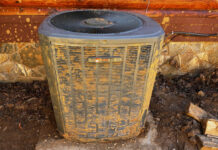 This is the exterior portion of our heat pump after we dug it out, straightened it out, and the service technician used a stiff brush to clean off the enclosure.