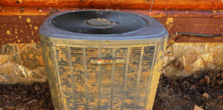 This is the exterior portion of our heat pump after we dug it out, straightened it out, and the service technician used a stiff brush to clean off the enclosure.