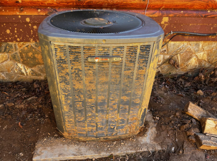 This is the exterior portion of our heat pump after we dug it out, straightened it out, and the service technician used a stiff brush to clean off the enclosure.