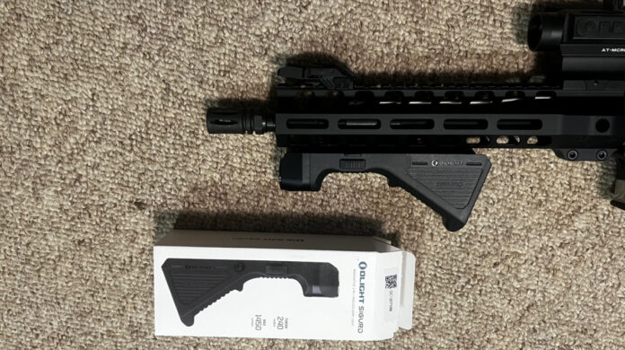 The angled foregrip mounted on this AR pistol has an integra; 1450 lumen flashlight.