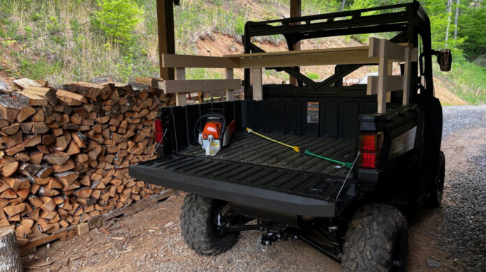Polaris Bed The bed on our Polaris Ranger now has a wooden rail system around it to better hold in firewood and other loads.